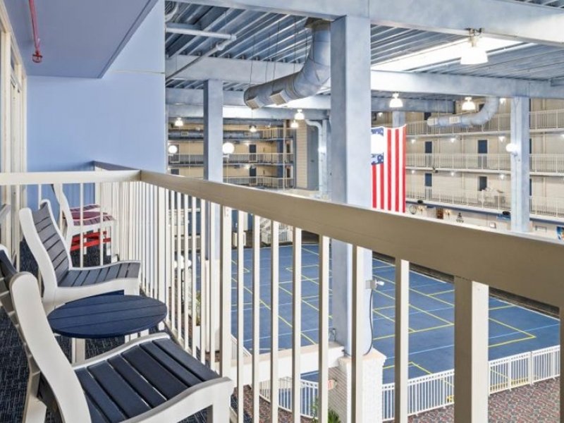 a balcony with chairs and an american flag