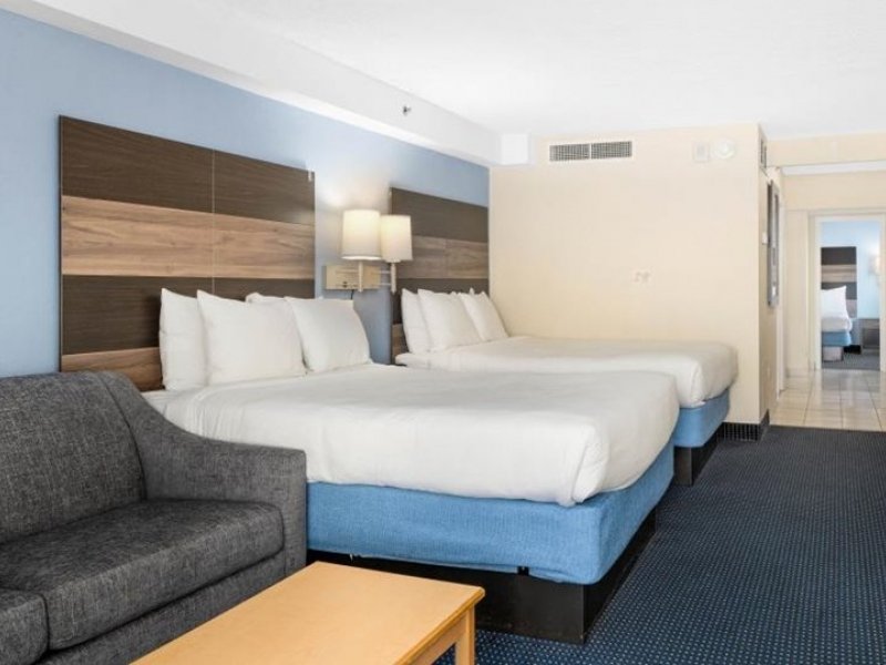 a hotel room with two beds and a couch