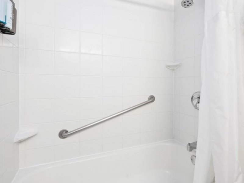 a bathroom with a white shower curtain and toilet