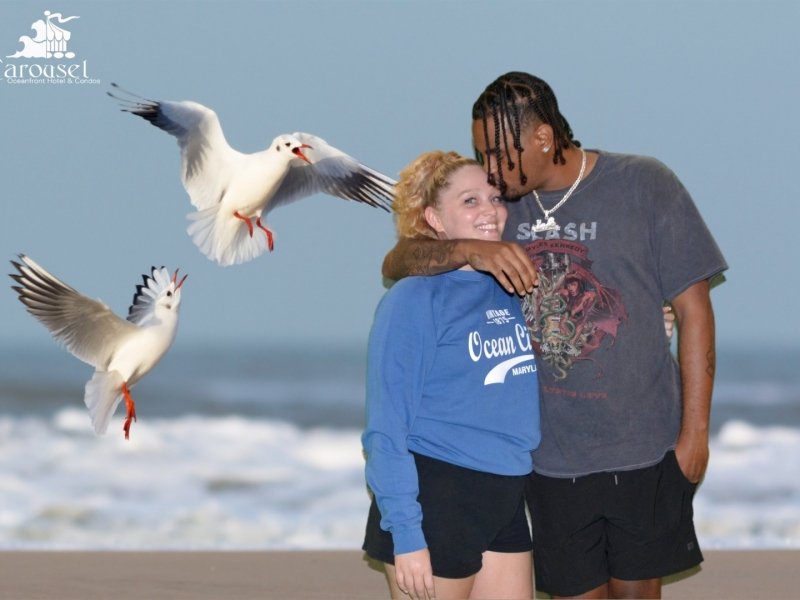 two people hugging on the beach with seagulls in the background