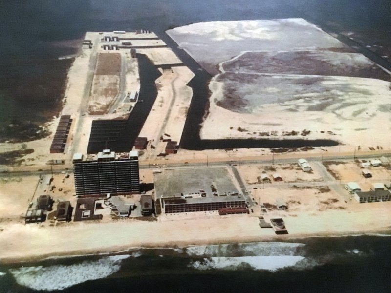 an aerial view of a large building in the middle of the ocean